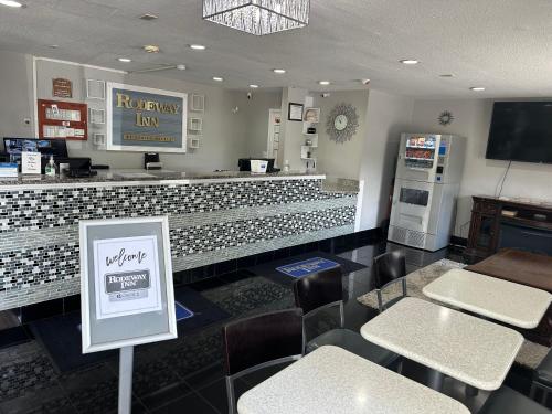 a fast food restaurant with a counter and chairs at Rodeway Inn Florence - Cincinnati South in Florence