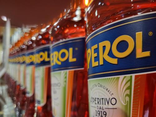 a row of bottles of alcohol on a store shelf at Penthouse CASA ALKEA Masse Lake view in Brenzone sul Garda