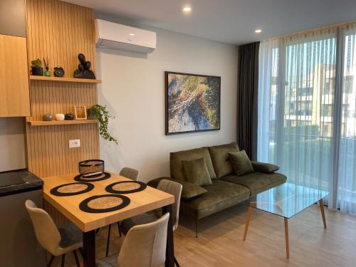 a living room with a couch and a table at Rosemarine Villas in Durrës