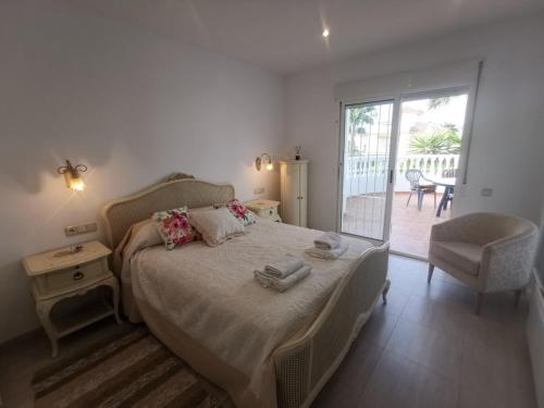 a bedroom with a large bed and a balcony at Luxury Paradise Beach Villa in Vera