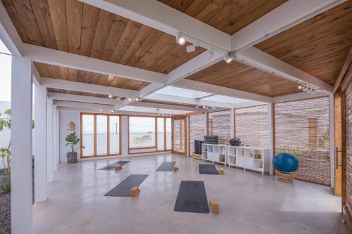 a gym with yoga mats in a room with wood ceilings at Shambhala Fuerteventura in Parque Holandes