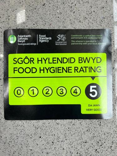 a sign for a food hygiene rating on a counter at Bryn Goleu Bed & Breakfast in Llandudno