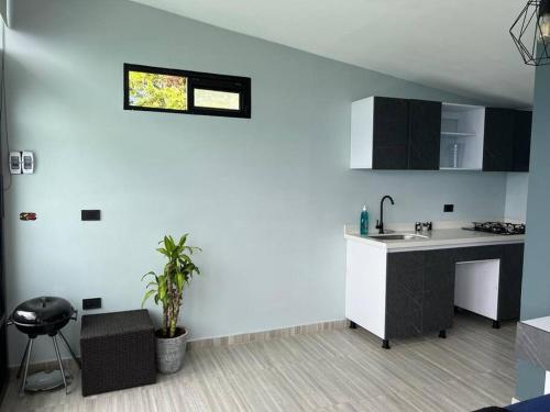 a kitchen with a sink and a counter top at Cabaña en Sopetran con jacuzzi in Sopetran