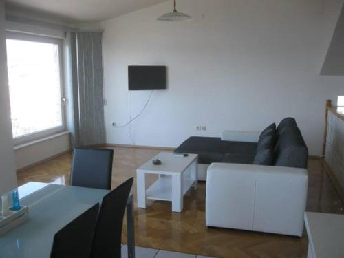 a living room with a couch and a table at Villa Curkovic in Ražanj