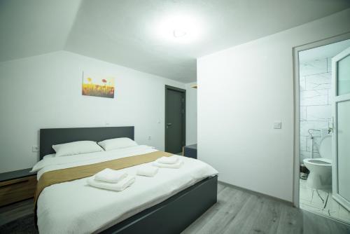 a bedroom with a bed with towels on it at Cabana de Sub Deal Arieșeni in Arieşeni
