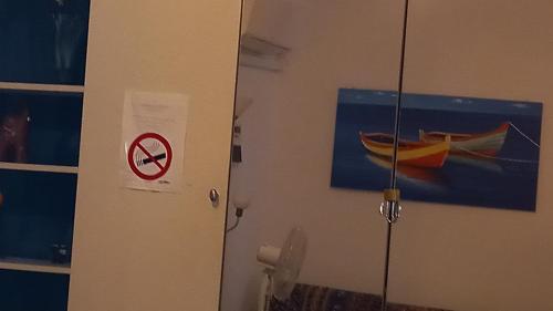 a wall with a no fishing sign and a picture of a boat at A Santy's Rooms-BAGNOCONDIVISO SHAREDBOTH ROOM2piano-no lift-3chilom a piedi xAEROPORTO-A PAGAMENTO AIR CONDIZextra bed EXTRABED FOR A FEE-3 MINUTI BUS XFIERADIROMA-10 MINUTES STOP BUS TO ROME IN50 MINUTES TRAFFICPERMITTING ARE YOU TO ROME in Fiumicino