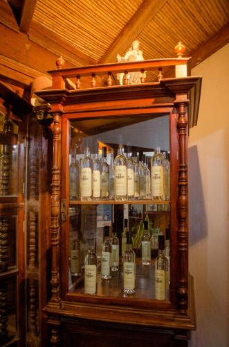 a cabinet filled with lots of bottles of alcohol at Hotel & Hacienda El Carmelo in Ica