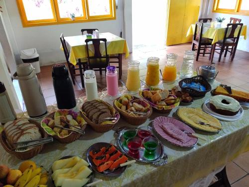 a table with a bunch of food on it at Cantinho do Vale Pousada in Penedo