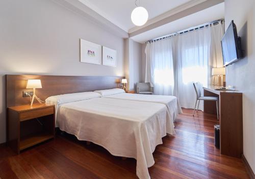 Ένα ή περισσότερα κρεβάτια σε δωμάτιο στο Hotel Prado Viejo