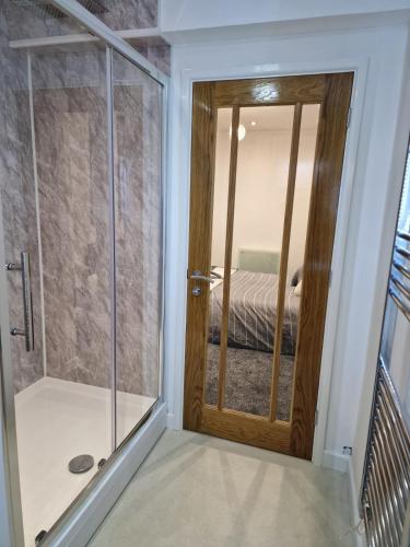 a bathroom with a shower and a glass door at Cosynitebnb for 4 in Birmingham
