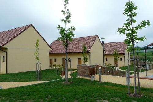 a row of houses with trees in a park at Resort Rybníček in Blatnice