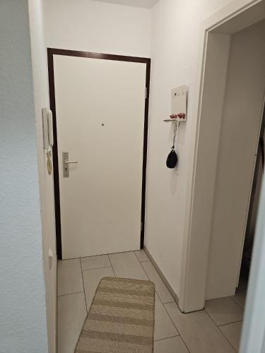 a white door in a room with a rug at City Appartement 2 Hannover Altstadt in Hannover