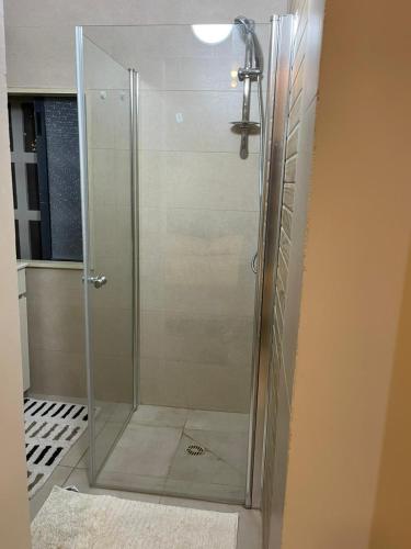 a shower with a glass door in a bathroom at Estrela Mares Haifa apartment in Haifa