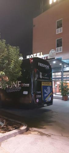 a black bus parked in front of a building at Hotel Il Duca d'Este in Ferrara