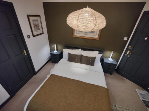 a bedroom with a large white bed with two night stands at Achalochan House in Ose