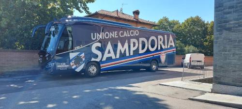 a blue bus is parked in a parking lot at Hotel Il Duca d'Este in Ferrara