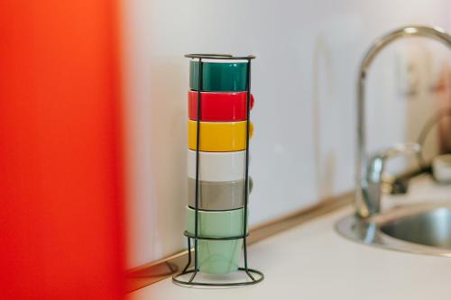 a colorful cylinder sitting on a counter next to a sink at Ferienapartments Müller in Ebene Reichenau