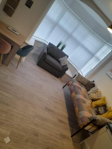 a living room with a couch and a chair at Flat 5 Corner House 1 bedroom in Doncaster