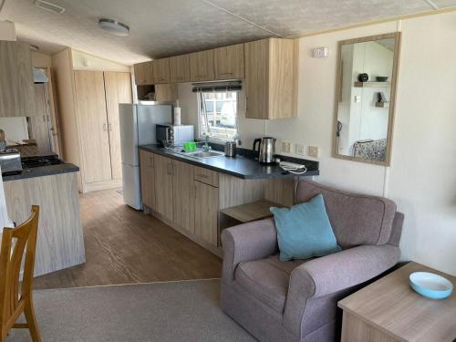 a living room with a couch and a kitchen at The Breakaway in Rochester