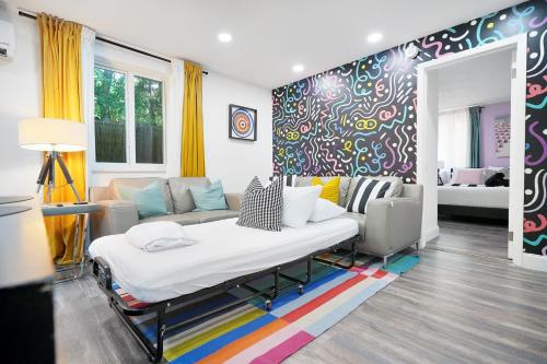 a living room with a bed and a couch at Vacay Spot Wynwood Deco 2 Kitchens Shower Massage jets, BBQ, Patio LED vibes, Prime LOC! 6 blocks away from Bars, Nite Clubs, Res, Shops in Miami