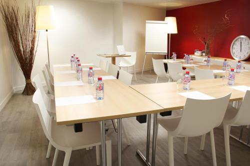 a room with tables and chairs with water bottles on them at Hotel Le Richemont in Paris