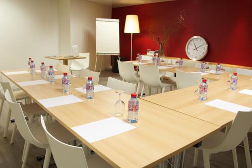 a conference room with tables and bottles of water on them at Hotel Le Richemont in Paris