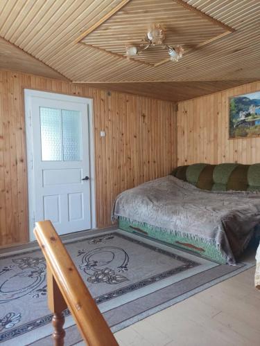 a bedroom with a bed and a ceiling at Borgaza in Yaremche