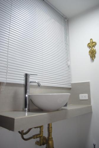a bathroom with a sink and a window at Luxury 79 in Bogotá