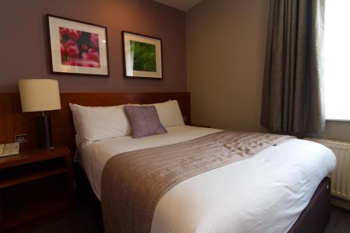 a hotel room with a bed and a window at Best Western Ship Hotel in Weybridge