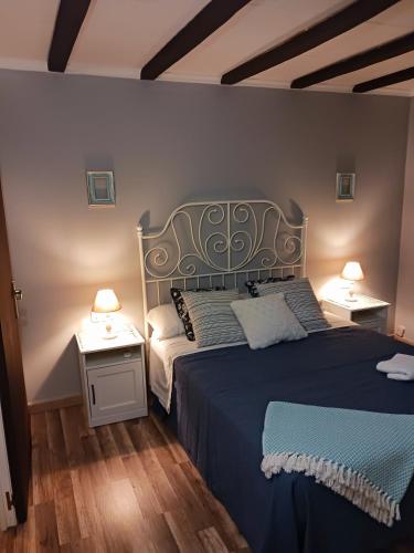 a bedroom with a large bed with two night stands at EL LLIMONER in Sant Jordi