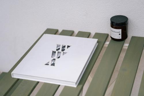 a book sitting on a bench next to a bottle of ink at Żoliborz Business Apartments by Rentujemy in Warsaw