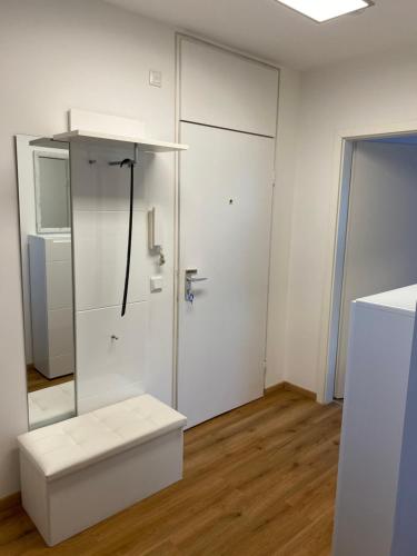 a white room with a white bench and a door at Marl Central Apartment in Marl