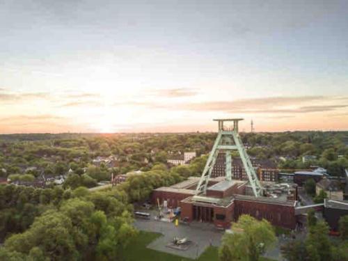 an overhead view of a building with the sunset in the background at Suburban Jungle in Bochum