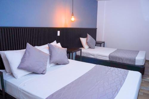 Postel nebo postele na pokoji v ubytování Hotel Palmas del Estadio