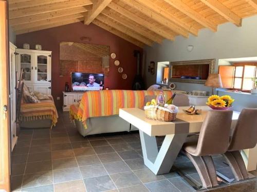 a living room with a couch and a television at Heu’s Monte in Odemira