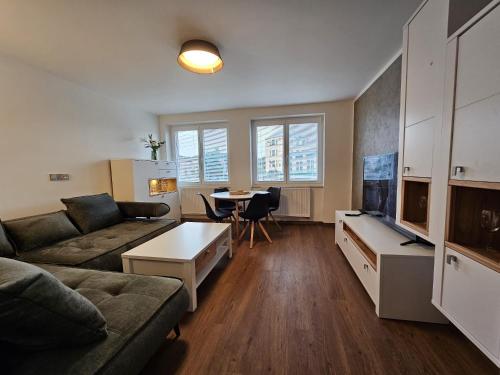 a living room with a couch and a table at Apartmán U Labe in Nymburk