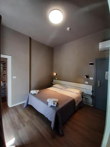 a bedroom with a large bed with towels on it at Hotel Alabama by ALEhotels in Rimini