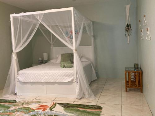 a bedroom with a bed with a canopy at Mango Cove Villa 