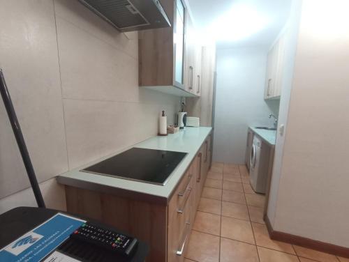 a small kitchen with a sink and a counter at VIVIENDAS RURALES LAS CALDERAS in Santillana del Mar