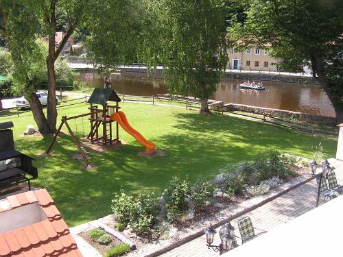 a playground in a park with a slide at Hotel Růže in Rožmberk nad Vltavou