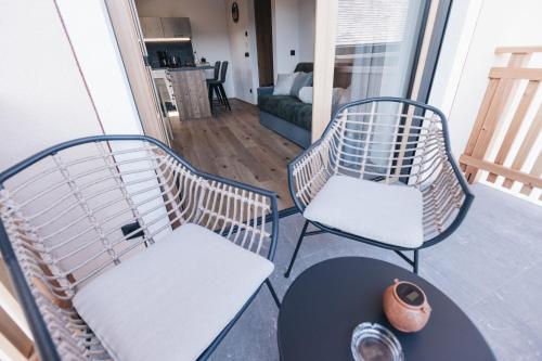 a balcony with two chairs and a table and a table at Flaschtal-Hof in Nova Ponente