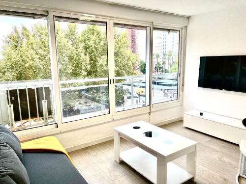 a living room with a couch and a large window at Ducado 41 Playa in Benidorm