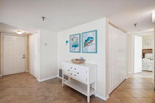 a room with white walls and a white dresser at Trillium 2A - Premier in St Pete Beach