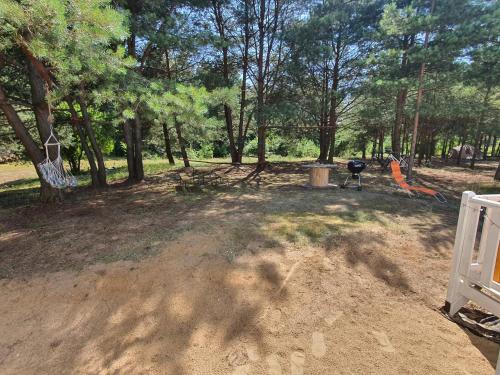 a park with a swing set and a playground at Holenderki na Zielonych Wzgórzach, Łowyń in Łowyń