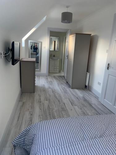 an empty room with a bed and a hallway at Connemara Ocean Escape in Galway