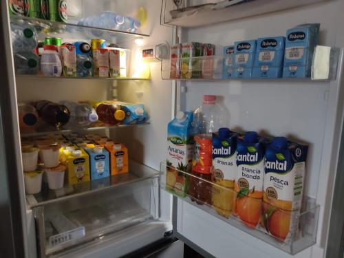 an open refrigerator filled with lots of drinks and drinks at Domo Is Domus in SantʼAnna Arresi