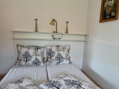 a room with two pillows and a shelf on the wall at Pod Modrzewiami in Milówka