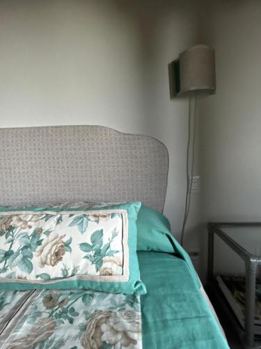 a bed with a pillow and a lamp in a room at Bed&Breakfast La Madonnina in Marlia