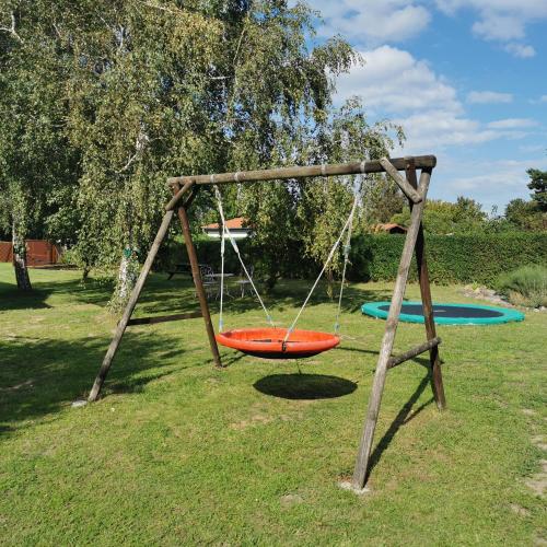 an orange swing set in a park at Wohlfuehl-Orte24 am Hafen in Schaprode, Rügen in Schaprode