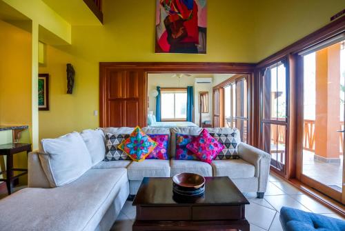 a living room with a couch and a table at The Villas at Cocoplum in Placencia Village